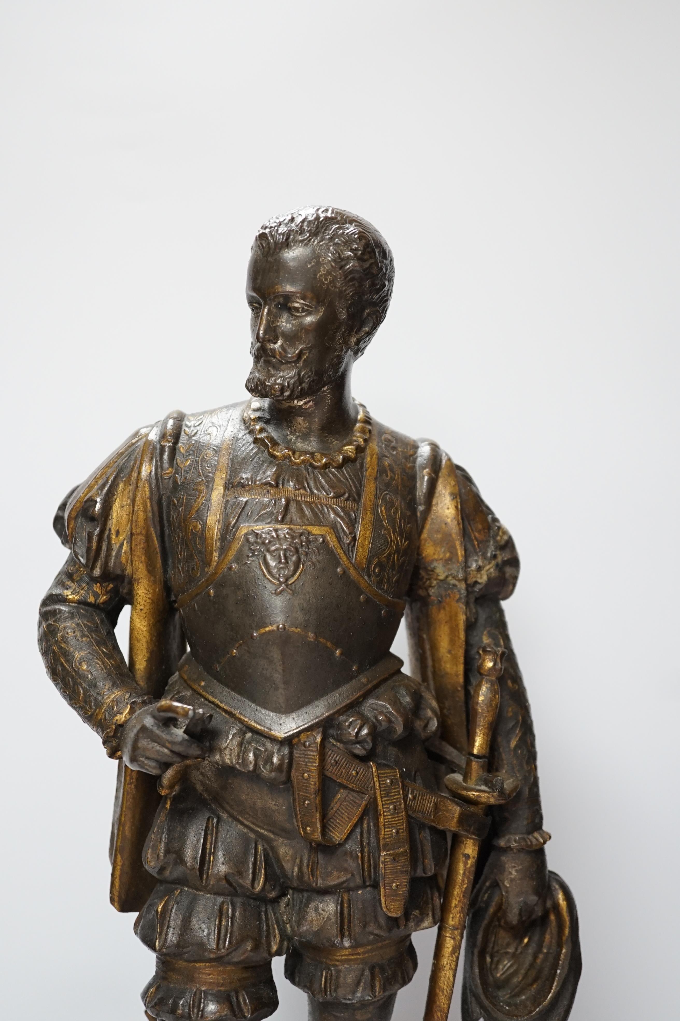 A 19th century parcel gilt and bronzed spelter figure of a cavalier, together with a Florentine style bronze ewer, 49cm high (the latter a.f.) (2)